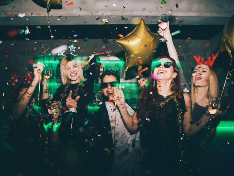 a group of young attractive people having fun in a Krakow bar