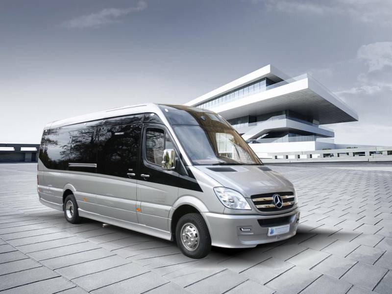 a picture showing a minibus in front of an airport