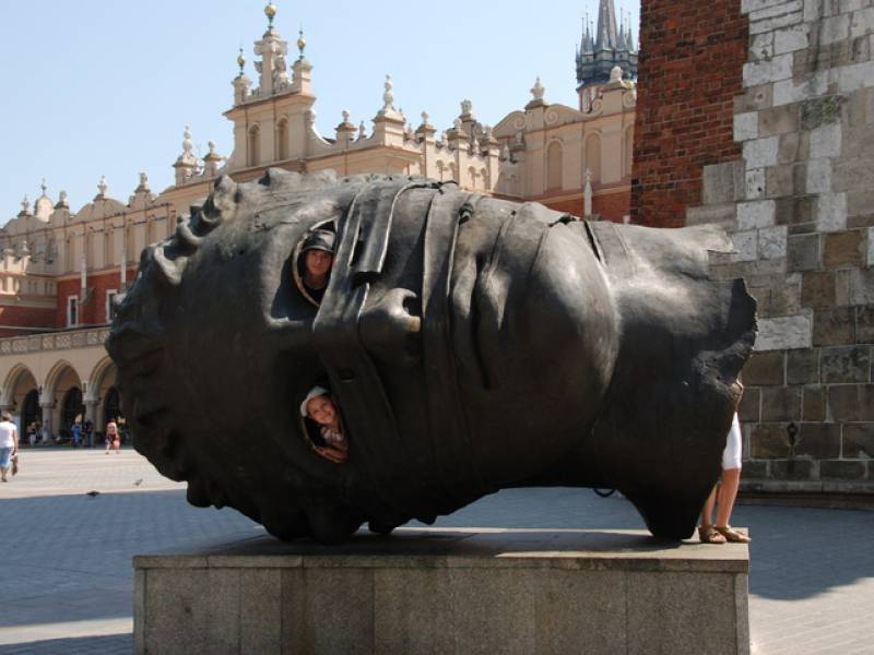 a picture showing a monument at Krakow Market Square