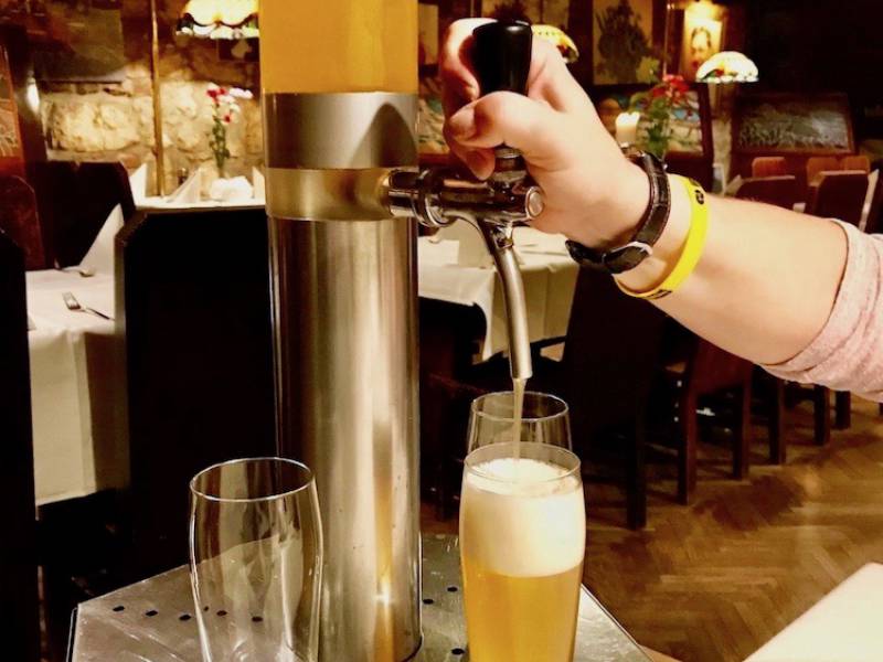 image showing beer pouring from a beer giraffe