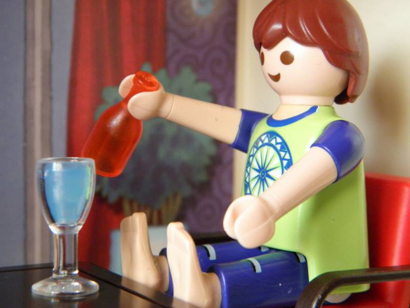 a lego man drinking